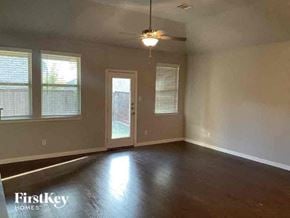 Celina house for rent - an empty living room with a door and a ceiling fan