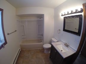 Fairbanks apartment for rent - A bathroom with a toilet, sink, and bathtub.