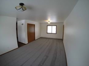 Fairbanks apartment for rent - A room with a carpeted floor and a window.