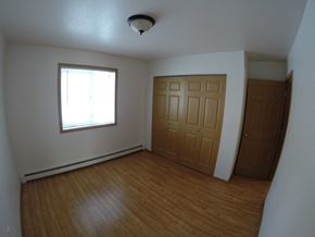 Fairbanks apartment for rent - A room with a window and a wooden door.
