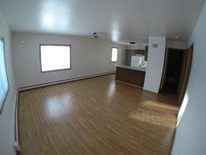 Fairbanks apartment for rent - A room with wooden flooring and white walls.