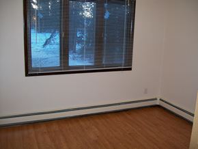 Fairbanks apartment for rent - A room with a window and wooden floors.
