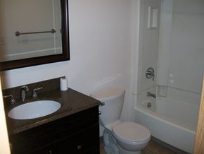 Fairbanks apartment for rent - A white toilet sits next to a sink in a bathroom.
