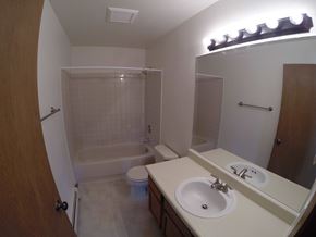 Fairbanks apartment for rent - A bathroom with a white sink, toilet, and bathtub.