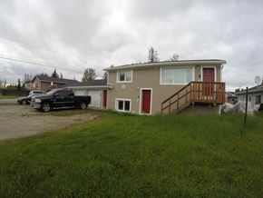 Fairbanks apartment for rent - A house with a red door and a brown deck.