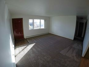Fairbanks apartment for rent - A room with a red door and a window with sunlight coming through.