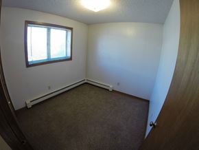 Fairbanks apartment for rent - A room with a carpeted floor and a window.