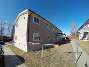Fairbanks apartment for rent - A small house with a fence in front of it.