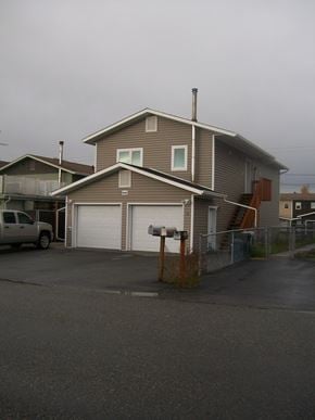 Fairbanks apartment for rent - A house with a garage and a car parked in front.