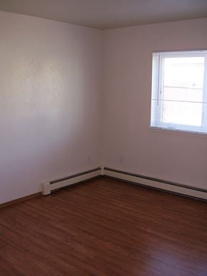 Fairbanks apartment for rent - A room with a window and wooden floors.