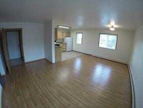 Fairbanks apartment for rent - A room with wooden floors and white walls.