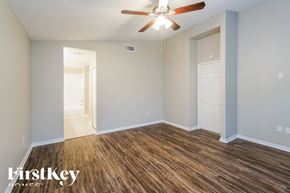 Wesley Chapel house for rent - a living room with wood flooring and a ceiling fan