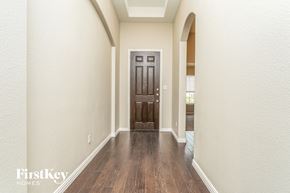 Fort Worth house for rent - an empty hallway with a wooden floor and a door