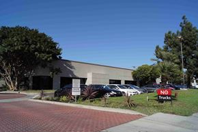 Long Beach apartment for rent - a building with cars parked outside and a no trucks sign