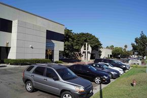 Long Beach apartment for rent - a parking lot full of cars in front of a building