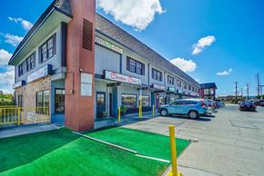 Torrance apartment for rent - a building with a parking lot and cars parked in front of it