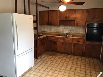 Cincinnati house for rent - a kitchen with a refrigerator and a sink