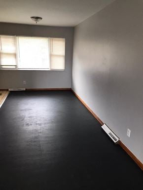 Cincinnati house for rent - an empty room with black carpet and a window