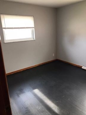 Cincinnati house for rent - an empty room with a window and wooden floors