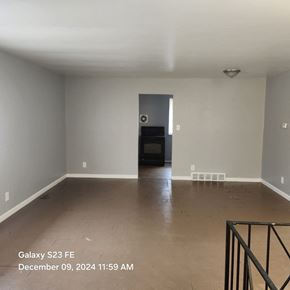 Cincinnati apartment for rent - A room with a door and a window, with a black metal frame on the right side.