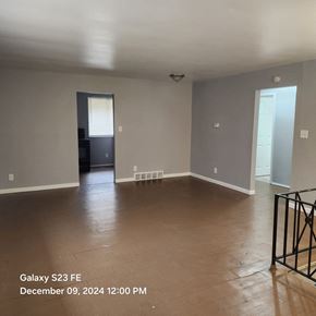 Cincinnati apartment for rent - A spacious room with a door on the left and a window on the right.