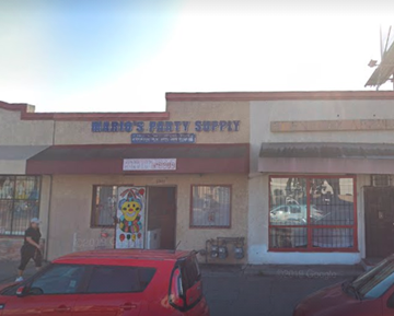 Lynwood apartment for rent - A red car is parked in front of Mario's Party Supply.