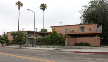 Woodland Hills apartment for rent - a building on the side of a street with palm trees