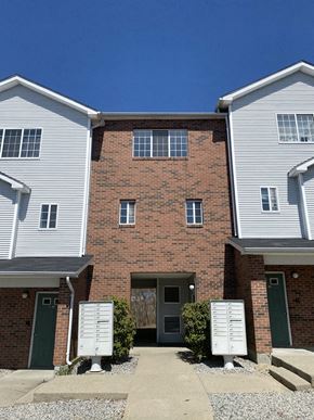 West Warwick apartment for rent - a brick building with a driveway in front of it
