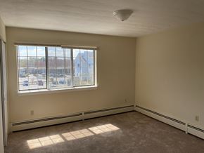 West Warwick apartment for rent - the living room of an empty house with a large window