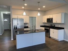 Penn Yan apartment for rent - a kitchen with white cabinets and stainless steel appliances