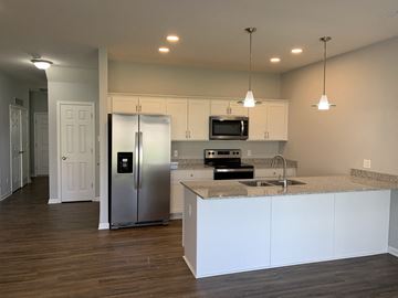 Penn Yan apartment for rent - a kitchen with white cabinets and a stainless steel refrigerator