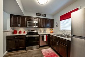 Apex apartment for rent - Renovated kitchen with dark cabinetry and stainless steel appliances.
