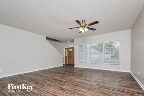 Riverview house for rent - A room with a ceiling fan and wooden flooring.