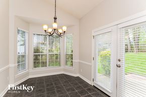 Huntersville house for rent - a dining room with large windows and a chandelier