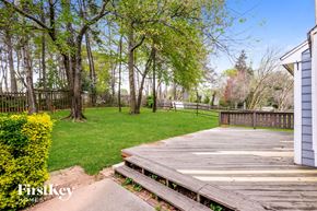 Huntersville house for rent - a backyard with a wooden deck and grass and trees