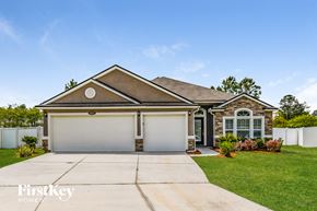 Jacksonville house for rent - A house with a brown roof and a white garage door.