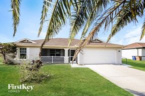 Lehigh Acres house for rent - a house with palm trees in front of it