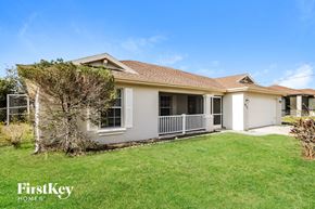 Lehigh Acres house for rent - a white house with a lawn and a porch