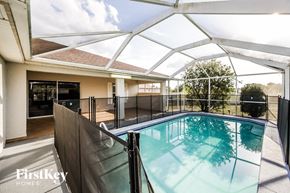 Lehigh Acres house for rent - the pool is under a glass roof in the backyard of a house