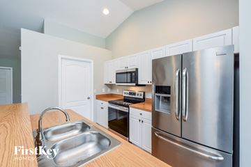 Lehigh Acres house for rent - A kitchen with a stainless steel refrigerator and a wooden countertop.