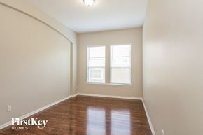 Orange Park house for rent - a empty room with a wooden floor and two windows