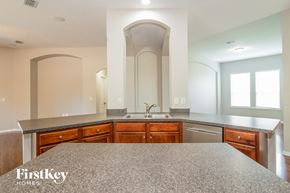 Orange Park house for rent - a kitchen with granite counter tops and wooden cabinets