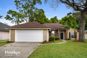 Jacksonville house for rent - a home with a white garage door and a lawn