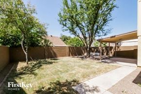 Chandler house for rent - a backyard with trees and a fence and a house