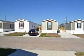 Houston apartment for rent - a car parked in front of a row of mobile homes