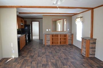 Houston apartment for rent - an open living room with a kitchen and a wood floor