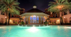 Houston apartment for rent - Resort-style pool with fountains, pool-side lounge chairs, and palm trees at Tuscany Court Apartments in Houston.