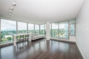 Vancouver apartment for rent - A spacious living room with a view of the cityscape outside the large windows.