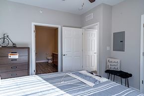 Shelbyville apartment for rent - a bedroom with a bed and an open door to a bathroom