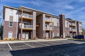 Shelbyville apartment for rent - an exterior view of an apartment building with a parking lot